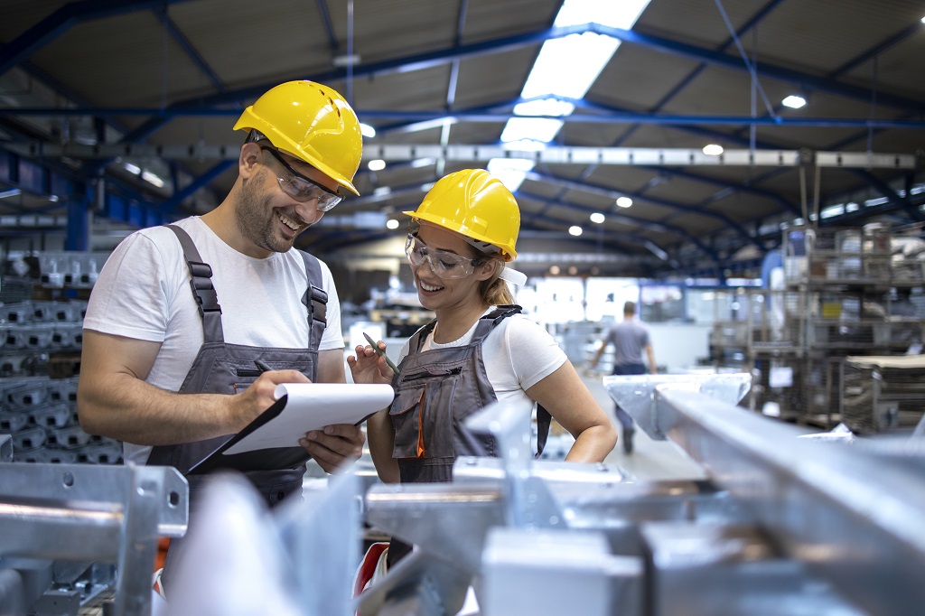 factory-workers-analyzing-production-results-in-large-industrial-hall.jpg