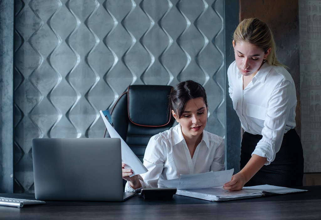 young-business-lady-female-director-sitting-office-desk-with-documents-working-process-business-meeting-working-with-colleague-solving-business-tasks-office-collective-concept.jpg