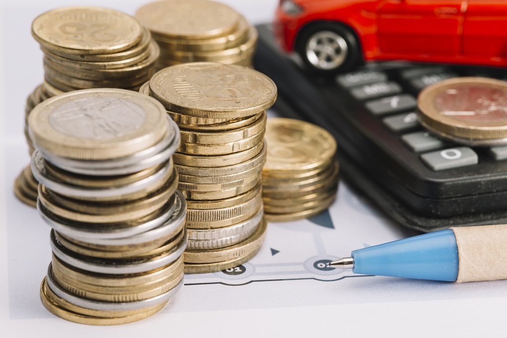 close-up-stacked-coins-pen-calculator.jpg